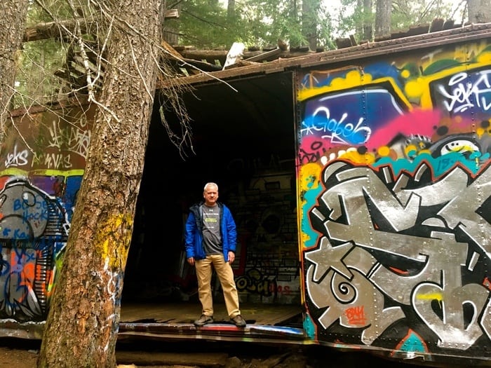 Trees and graffitti co-exist on the train wreck trail in b. C.
