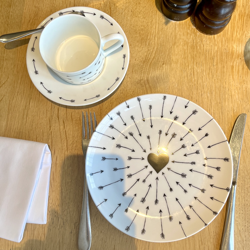 Black and white hearts and arrows feature on plates and cups at teh swan's romeo and juliet afternoon tea