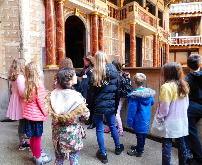 a young tour guide tells kids about shakespeare's globe theater