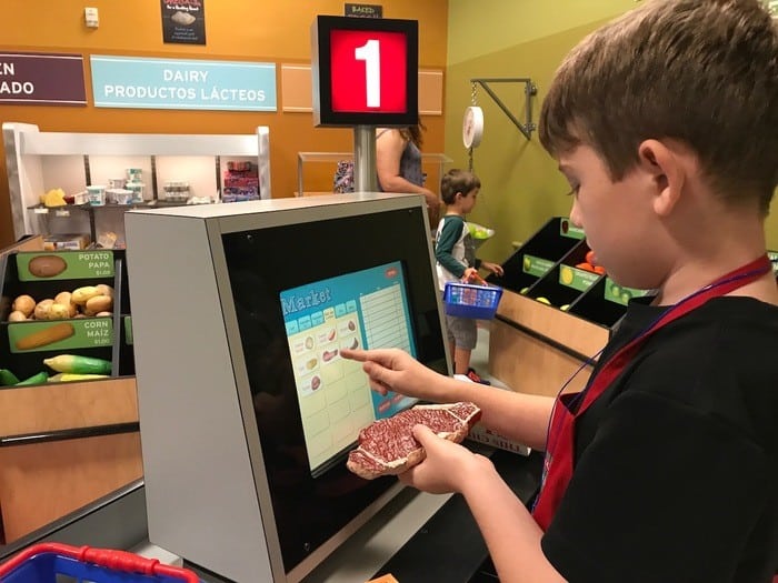 Buying groceries at kidtropolis a the houston childrens museum