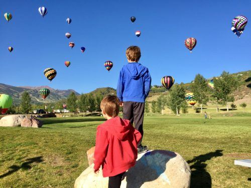 Kids watch balloons in the early morning at balloonfest