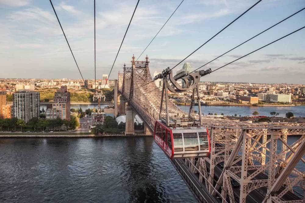 the roosevel island tram next to the 59th street bridge