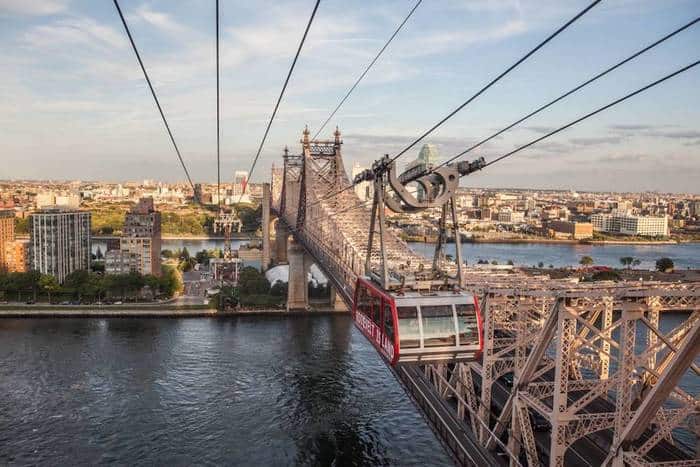 The roosevel island tram next to the 59th street bridge