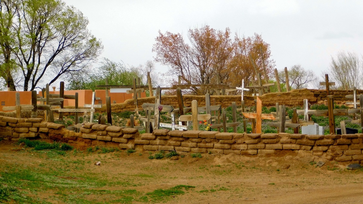 Taos Offers Authentic New Mexico Things To Do With Kids: The cemetery at Taos Pueblo is filled with simple wooden crosses.