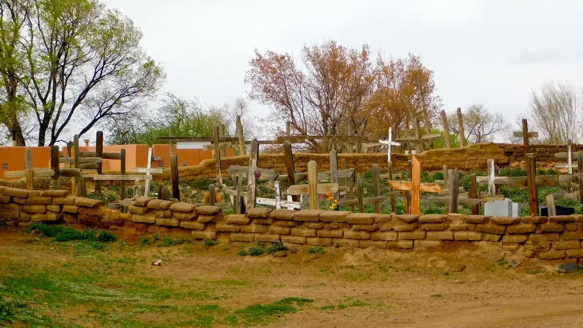 Taos Offers Authentic New Mexico Things To Do With Kids: The cemetery at Taos Pueblo is filled with simple wooden crosses.