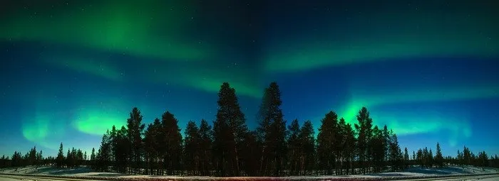 blue and green northern lights in lapland
