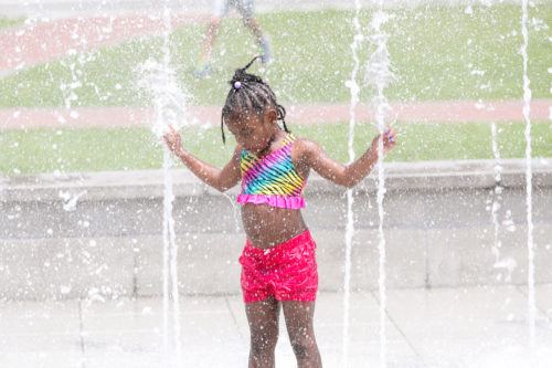 kids love to cool off in the fountains on savannah's  ellis square.