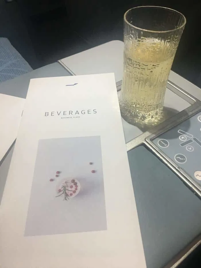 champagne and a dinner menu in finnair business class
