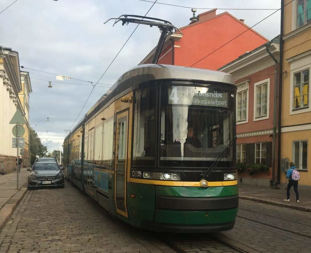 a street tram heads towards helsinki's senate square.