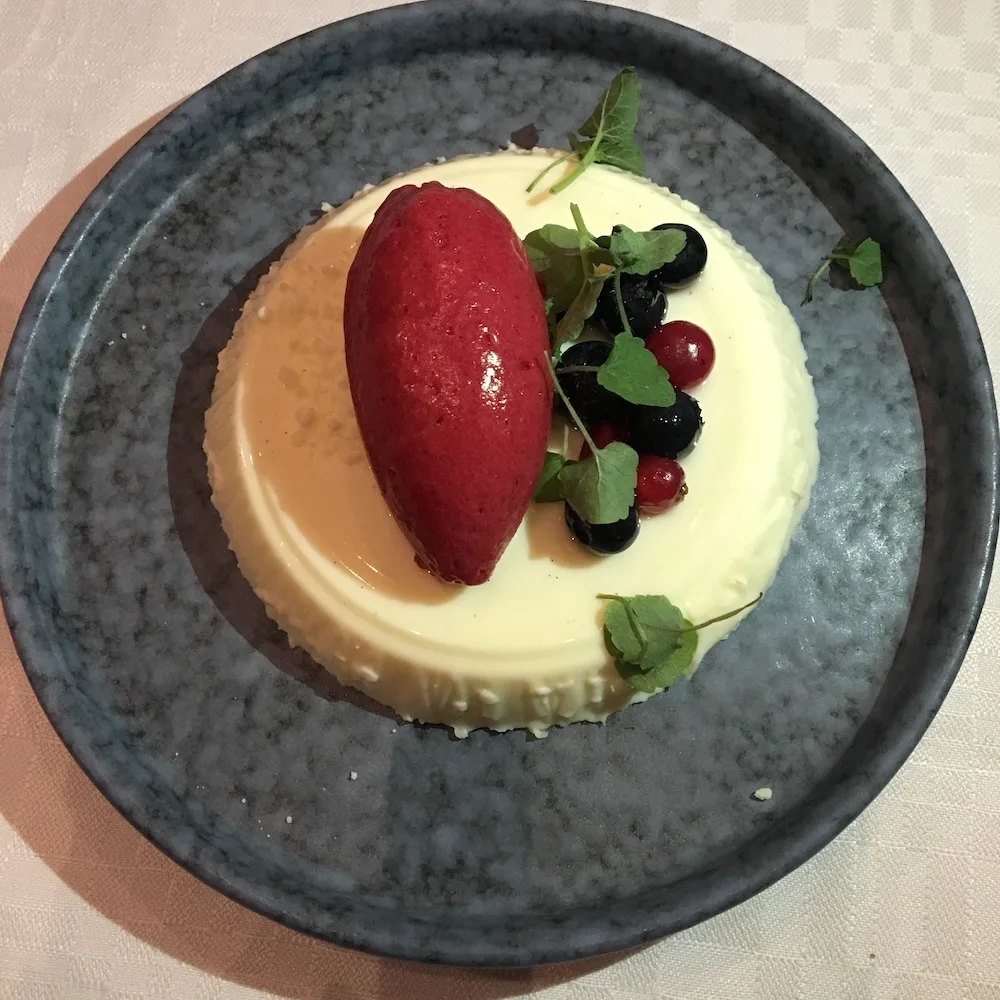 A vanilla mousse with lingonberry ice cream, a fancy dessert that will please kids in helsinki