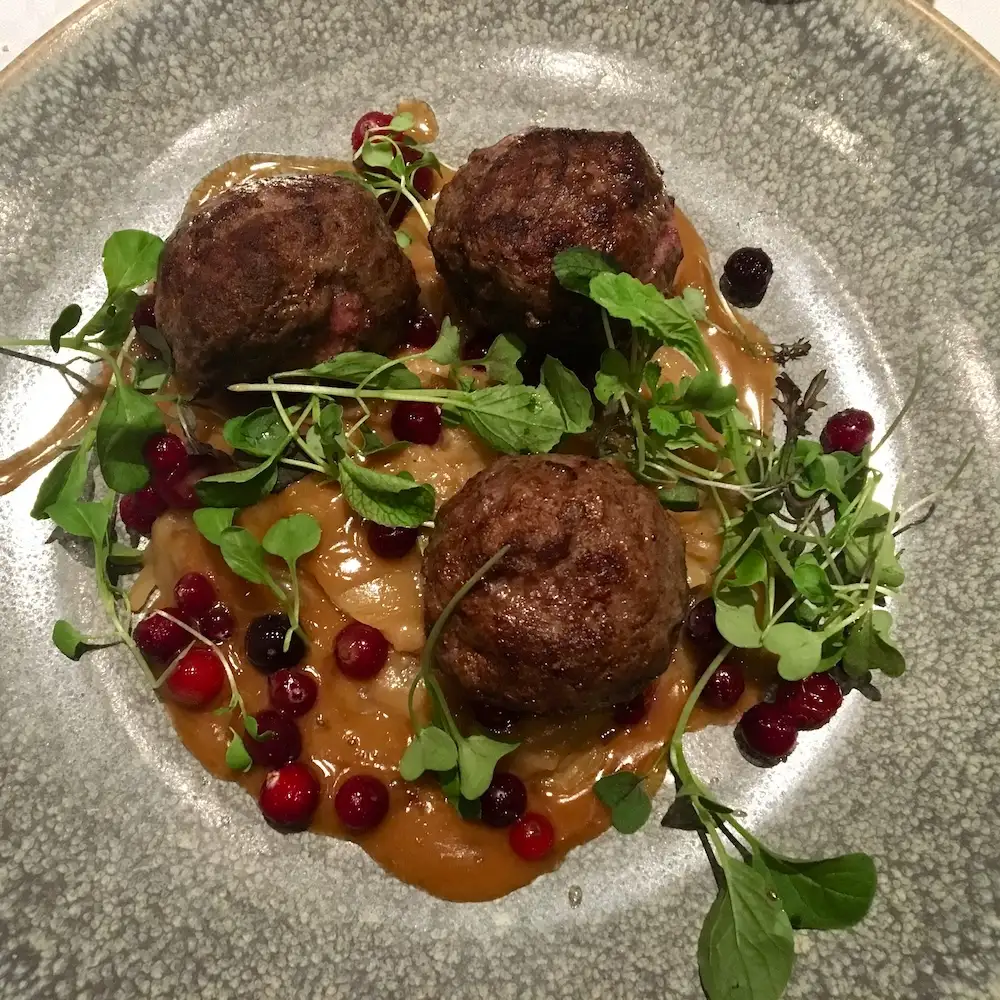 Finnish meatballs with gravy and lingonberries at salutorget in helsinki.