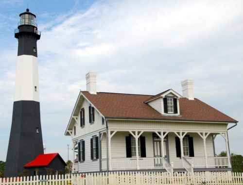 the lighthouse on tybee island is a classic striped tower that tourists love to visit.