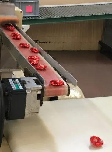 chocolate coming off the wrapping machine at whetstone's chocolates.
