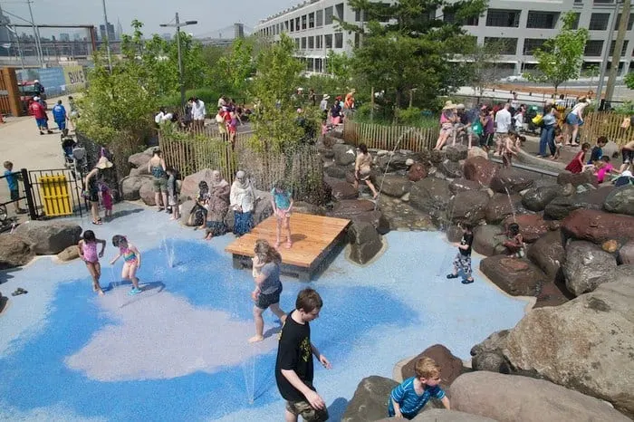 kids, parents and grandparents all get wet in the waterplay area at brooklyn's pier 6.