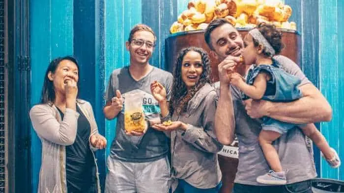 a group tries flavored popcorn on chicago food planet's navy pier tour.