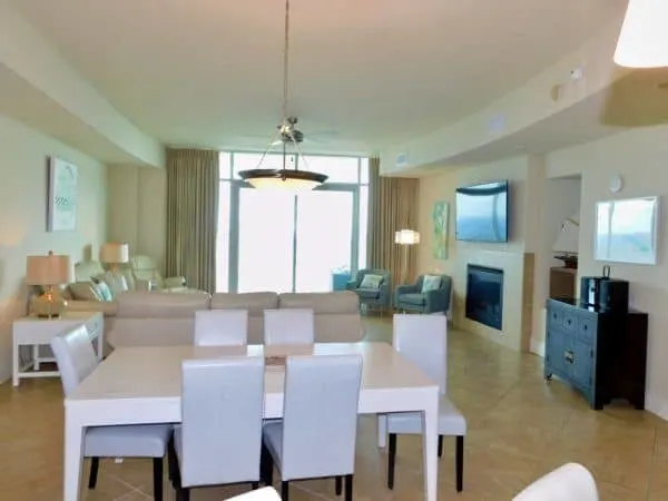 the living and dining area of a spacious gulf shores condo