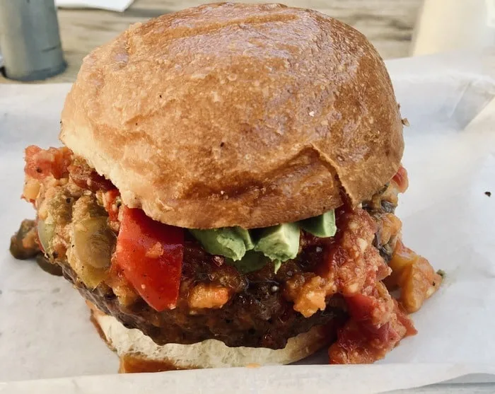 a burro alley burger with avocado and habanero jam.