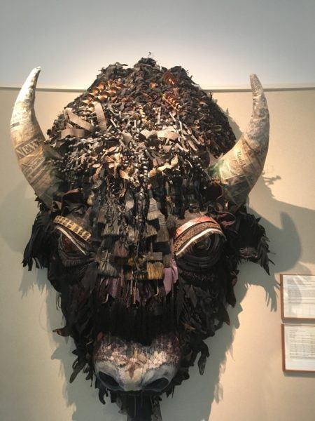 a paper maché buffalo head hangs in the new mexico capital building.