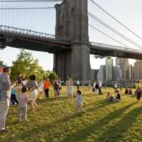 a nice lawn with skyline views at Empire Fulton Ferry Park