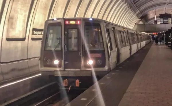 the washington dc metro pullin into a station. 
