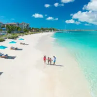 a family walking on a Beaches Resorts Beach.