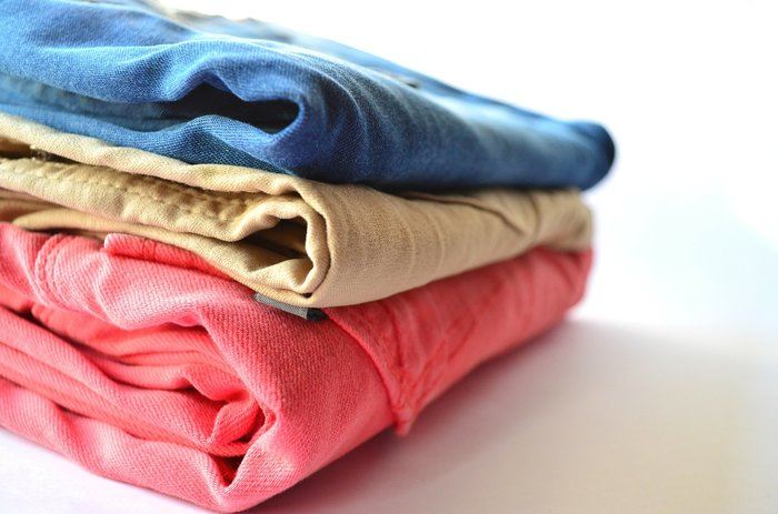A pile of folded laundry. Letting someone else doing the washing and folding for you on vacation can help you enjoy your time away more.