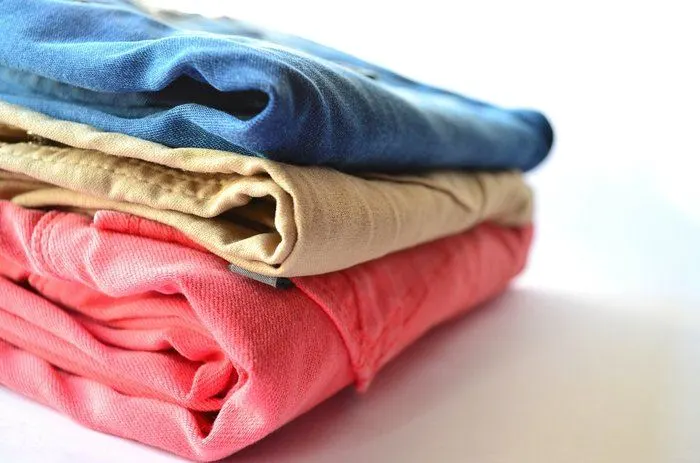 a pile of folded laundry. letting someone else doing the washing and folding for you on vacation can help you enjoy your time away more.