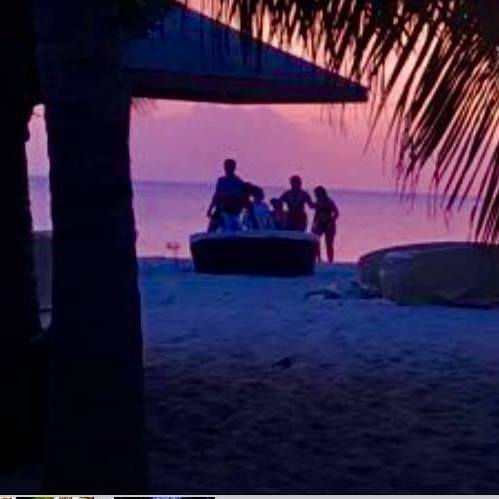 a family enjoys a sunset at jacqui o's on antigua