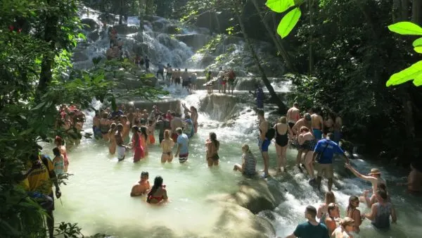 The Best Things To Do With Kids On 7 Caribbean Islands lots of tourists enjoying dunn's falls in jamaica