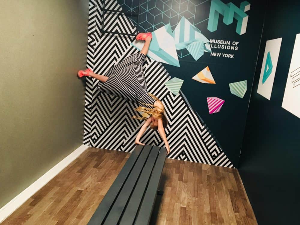 Doing a handstand at the museum of illusions