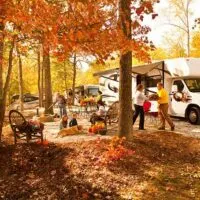 A family RV camping in the fall.