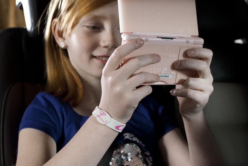 Tween buried in her screen in the car.