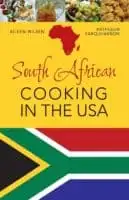 the cover of south african cooking in the usa features the national flag and typical dishes.