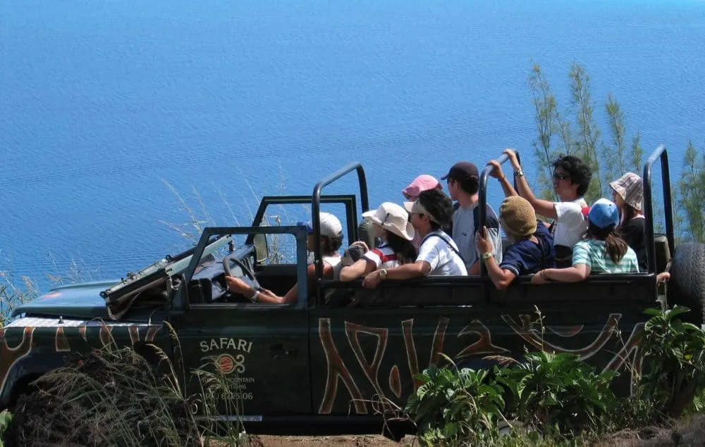a family on a 4x4 jeep safari on bora bora. amazing views.