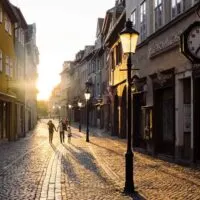 family walking in a European city pedestrian zone at sunset