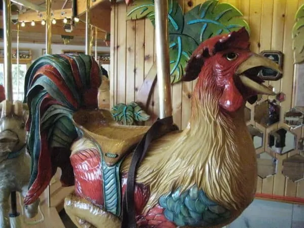 ride this colorful rooster on the carousel at lark toys in wisconsin. 