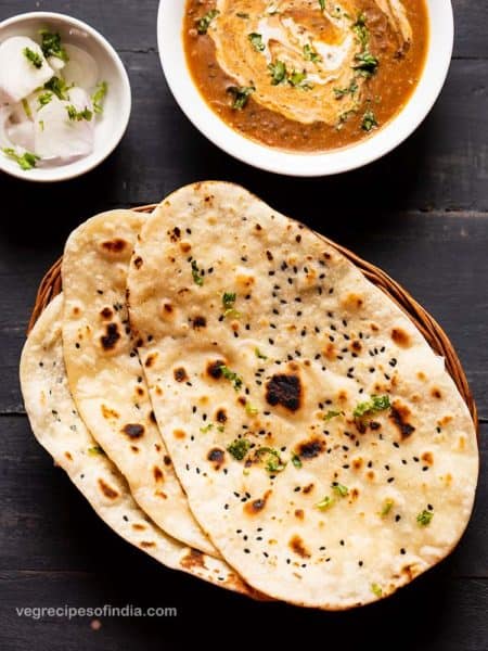 Indian naan alongside curry and onions.