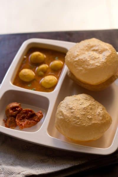 airy round poori with vegetarian indian food.