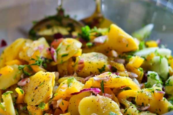 German potato salad has onions, bacon, parsley and vinegar.