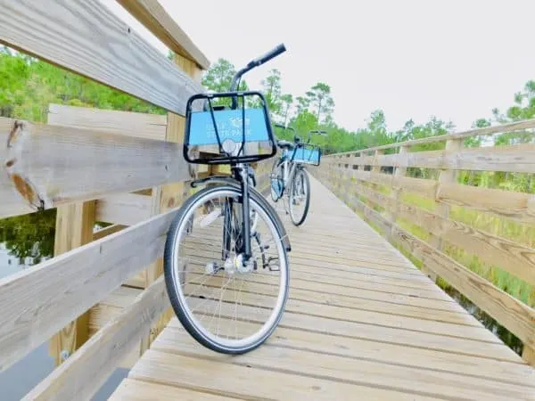 Take Your Kids To Gulf Shores, Al free borrowed bikes on a wooden board walk in gulf shores state park