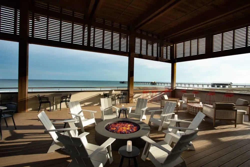 the expansive beach front deck with a fire pit at the lodge at gulf state park.