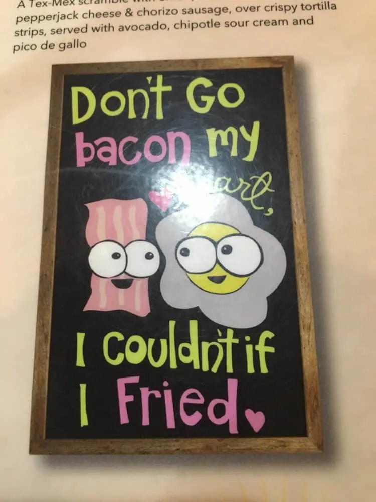 a punny sign about bacon and eggs at ruby slipper