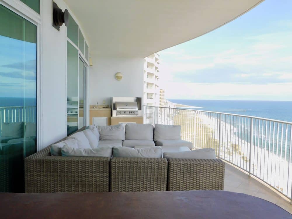 The patio that's also a outdoor living room for a turquoise place condo.