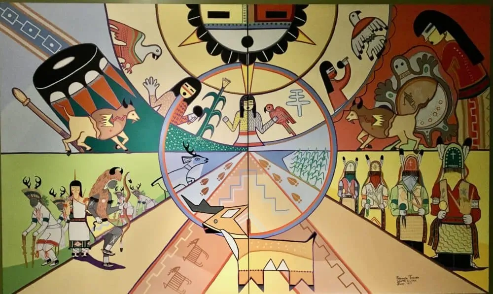 a mural depicting aspects of pueblo indian life at the pueblo cultural center. 