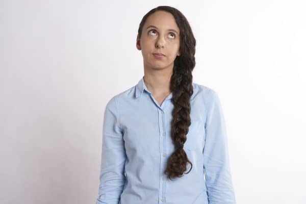 a teen rolling her eyes at her parents. 