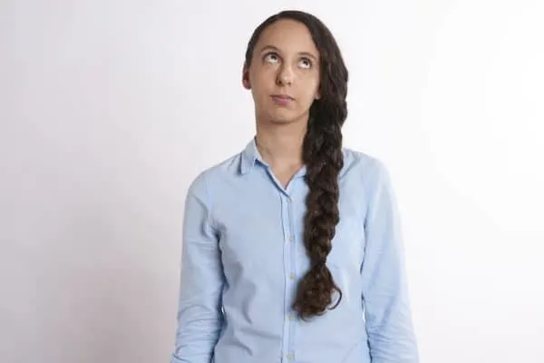 Here's How To Plan A Memorable Vacation With Your Teen a teen rolling her eyes at her parents.