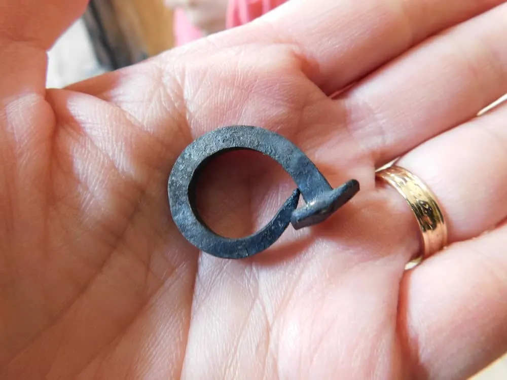 a nail hammered into a ring at the famers' museum blacksmith shop in upstate new york.