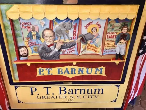 a tile on the empire state carousel celebrates new york native son p.t. barnum promoting his circus.