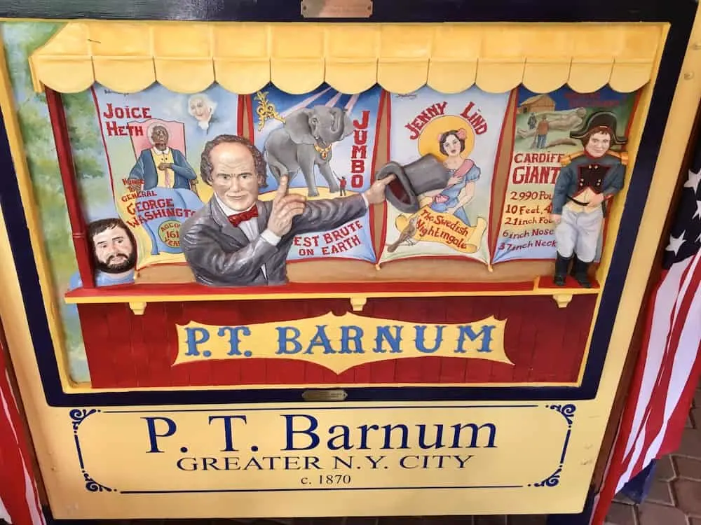 a tile on the empire state carousel celebrates new york native son p.t. barnum promoting his circus.