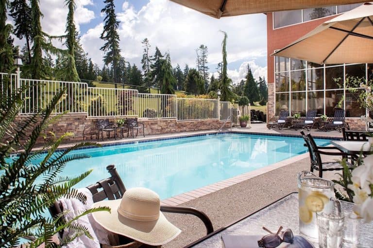 the large pool and wooded golf course outside of olympic lodge in port angeles